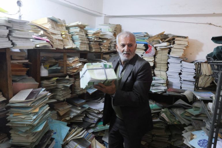 A 68-year-old man who owns a basement dedicated to books and sells or gives them away for free to those who cannot afford them, in an effort to promote reading, works inside the basement near Al-Mutanabbi Street in Baghdad, Iraq, December 13, 2025.