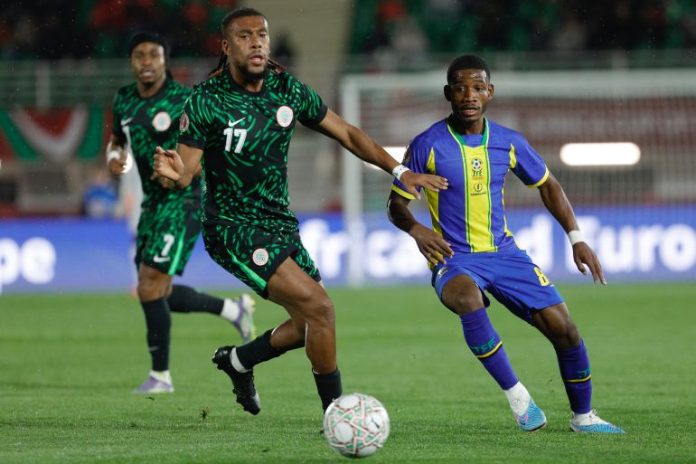 Nigeria's forward #17 Alex Iwobi and Tanzania's midfielder #08 Charles M'Mombwa vie during the Africa Cup of Nations (CAN) Group C football match between Nigeria and Tanzania at Fez Stadium in Fes on December 23, 2025.