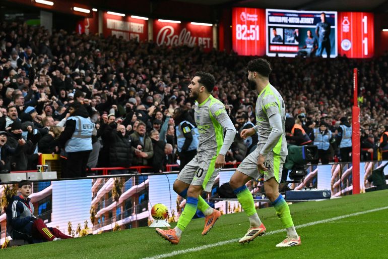 Manchester City's French midfielder #10 Rayan Cherki (C) celebrates after scoring their second goal during the English Premier League football match between Nottingham Forest and Manchester City at The City Ground in Nottingham, central England, on December 27, 2025.