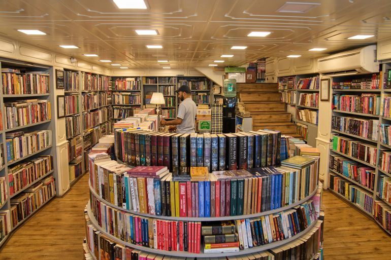 A Kashmiri man arranges books in a bookstore in Srinagar, Indian controlled Kashmir, Thursday, Aug. 7, 2025.