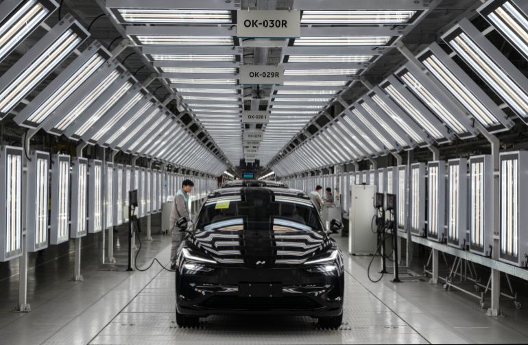 HEFEI, CHINA - JANUARY 17: A worker from Chinese electric vehicle (EV) company NIO checks the charging system during the final inspection of a car at the end of the automated production line at the companys manufacturing hub on January 17, 2025 in Hefei, China. China produces and exports more electric vehicles than any other country, leading the global electric vehicle (EV) market with production capacity that now outpaces domestic sales. Luxury brand NIO saw a 38% rise in EV deliveries in 2024 and is looking to further its expansion into overseas markets with a range of premium vehicles, a new lower priced sub-brand, and its battery swapping charging system. Exports of Chinese EVs exceeded two million for the first time in 2024, according to government figures. While the global expansion of Chinas EV industry has triggered trade tensions with the U.S. and Europe where governments are enacting tariffs on China-made electric cars, the companies are making inroads in markets in Asia, South America, and Africa. Chinese brands have become known worldwide for design and advanced EV technology at competitive prices, as they continue to fuel a transition to electric vehicles at home in the worlds largest car market.