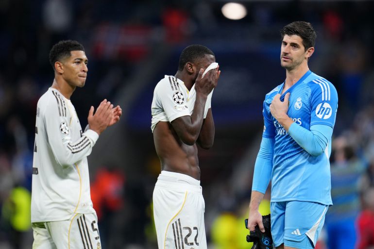 MADRID, SPAIN - DECEMBER 10: Jude Bellingham, Antonio Ruediger and Thibaut Courtois of Real Madrid react following the team's defeat during the UEFA Champions League 2025/26 League Phase MD6 match between Real Madrid C.F. and Manchester City at Estadio Santiago Bernabeu on December 10, 2025 in Madrid, Spain. (Photo by Aitor Alcalde/Getty Images)