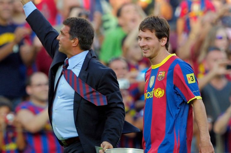 Barcelona's former president Joan Laporta (L) and Lionel Messi hold the Spanish first division trophy of the 2009-2010 season before a friendly match at Camp Nou stadium in Barcelona, August 25, 2010. REUTERS/Albert Gea (SPAIN - Tags: SPORT SOCCER)