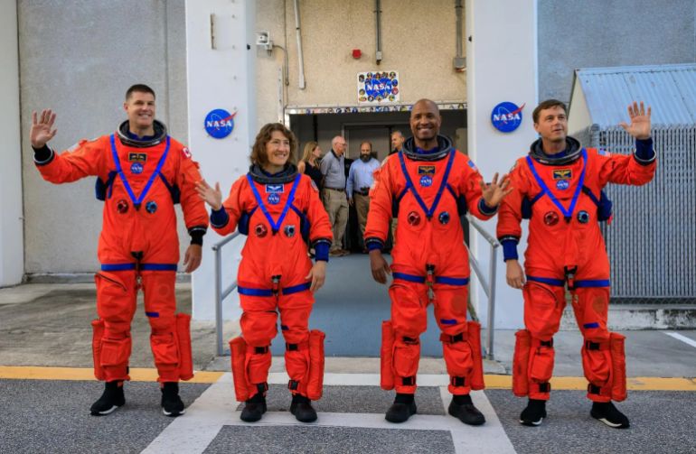 Artemis II crew members (from left) CSA (Canadian Space Agency) astronaut Jeremy Hansen, and NASA astronauts Christina Koch, Victor Glover, and Reid Wiseman walk out of Astronaut Crew Quarters inside the Neil Armstrong Operations and Checkout Building to the Artemis crew transportation vehicles prior to traveling to Launch Pad 39B as part of an integrated ground systems test at Kennedy Space Center in Florida on Wednesday, Sept. 20, to test the crew timeline for launch day.