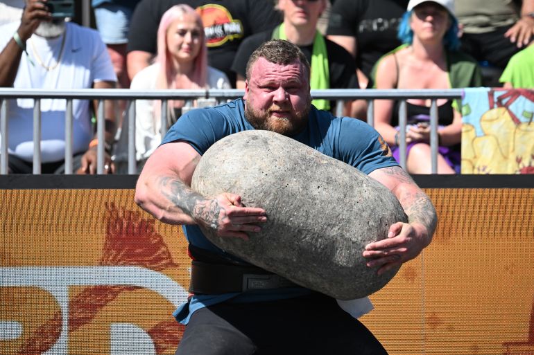 Tom Stoltman of Great Britain competes in the Natural Stone Medley during the qualifying round at the "World's Strongest Man" competition on May 16, 2025 in Sacramento, California. In the stone medley, the four stones, which weigh between 123kg (271lbs) and 181.5kg (400lbs) are either pressed, shouldered, carried or lifted to a platform, one after the other. Some people think weightlifters are "a lot of angry people who just like to throw weight around," 420-pound (190-kilogram) Australian Eddie Williams told AFP, but "I can be, you know, a happy person, and still be able to lift heavy weights."