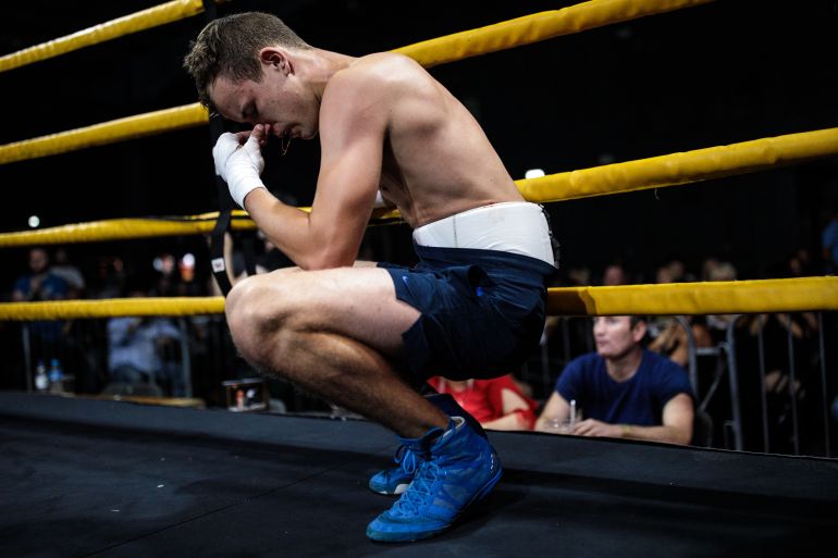 MANCHESTER, ENGLAND - AUGUST 04: A fighter from Wakefield takes a moment after being injured in his first ever bare-knuckle fight during an Ultimate Bare Knuckle Boxing (UBKB) event at Bowlers Exhibition Centre on August 4, 2018 in Manchester, England. The first formal bare-knuckle boxing bout in Britain was recorded in 1681 with the sport popularised by the end of the 17th century. The introduction of gloves into boxing with the Queensberry rules in 1867 eventually pushed bare-knuckle underground. Today the sport remains legal, but with no licensing body in place bare-knuckle in the UK is unregulated. Consisting of three 2-minute rounds or five 2-minute rounds for title fights, though rarely lasting that long, a fight sees boxers punch one another until knockout or until the referee or medic is forced to end it. Bare-knuckle boxing now looks set to shed its underground image and become more mainstream as the sports moves from pubs and car parks to bigger, more established venues.