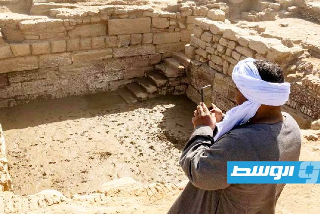 An Egyptian worker in front of the discovered lake at the Karnak complex in Luxor, southern Egypt.