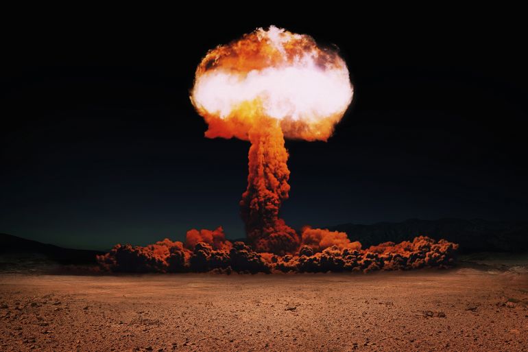 Terrible explosion of a nuclear bomb with a mushroom in the desert. Hydrogen bomb test. Nuclear catastrophe