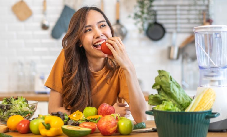 Portrait of beauty health asian woman having fun hold tomato cooking, vegan food healthy eat, fresh vegetable, Lycopene, vitamins, skincare, vegetarian in kitchen.Diet.Fitness, healthy food