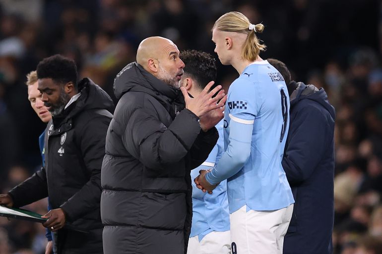 MANCHESTER, ENGLAND - FEBRUARY 04: Pep Guardiola, Manager of Manchester City, speaks with his player Erling Haaland ahead of being substituted onto the field during the Carabao Cup Semi Final Second Leg match between Manchester City and Newcastle United at Etihad Stadium on February 04, 2026 in Manchester, England.