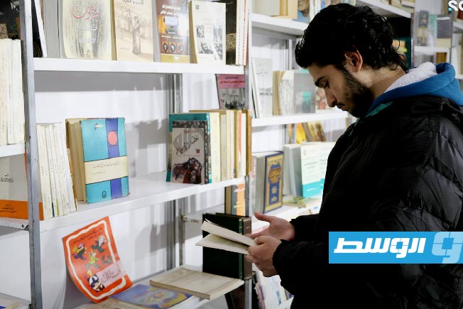 A visitor at the used book sellers 'Warraqin' pavilion at the Damascus International Book Fair 2026.