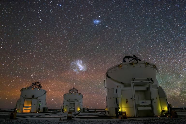 The Magellanic Clouds are satellite galaxies of the Milky Way. These dwarf galaxies, which orbit the galactic centre, are only visible from the Southern Hemisphere. Here, they are seen above the Auxiliary Telescopes of ESO's Very Large Telescope (VLT) in Paranal, Chile.